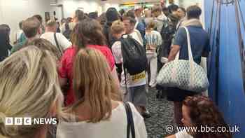 People stuck in airport corridor as shuttle stops