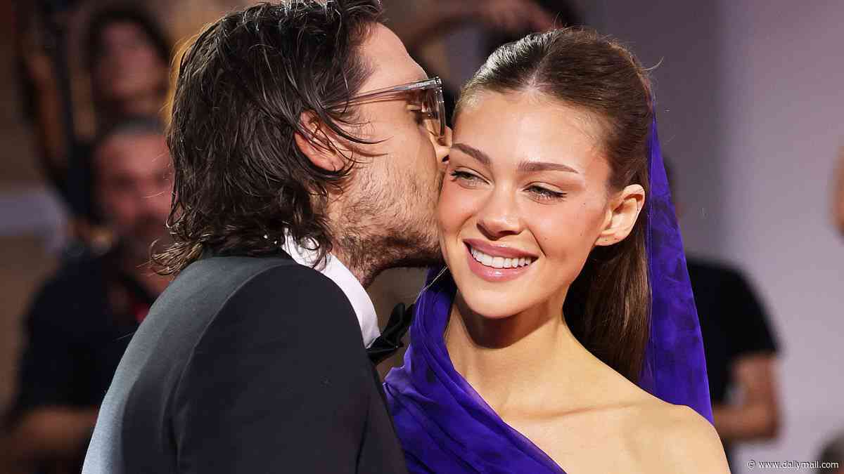 Nicola Peltz receives a kiss from husband Brooklyn Beckham and dazzles in a cut-out cobalt blue gown on the red carpet in Venice after accepting her Rising Star award