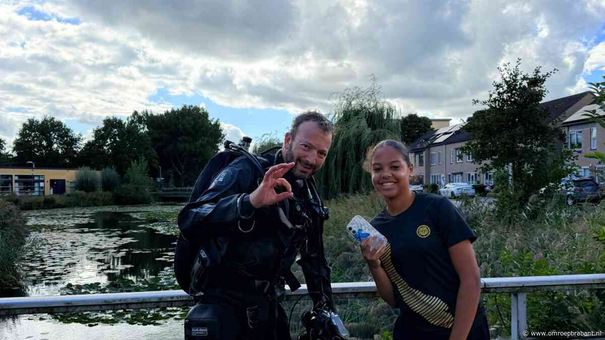 Tussen de blikjes in het water vist duiker Caithlin's  werkende telefoon op