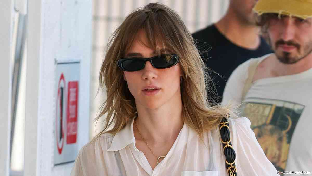 Suki Waterhouse and her fiancé Robert Pattinson sport cutting edge looks as they depart Venice Film Festival after loved-up red carpet appearance
