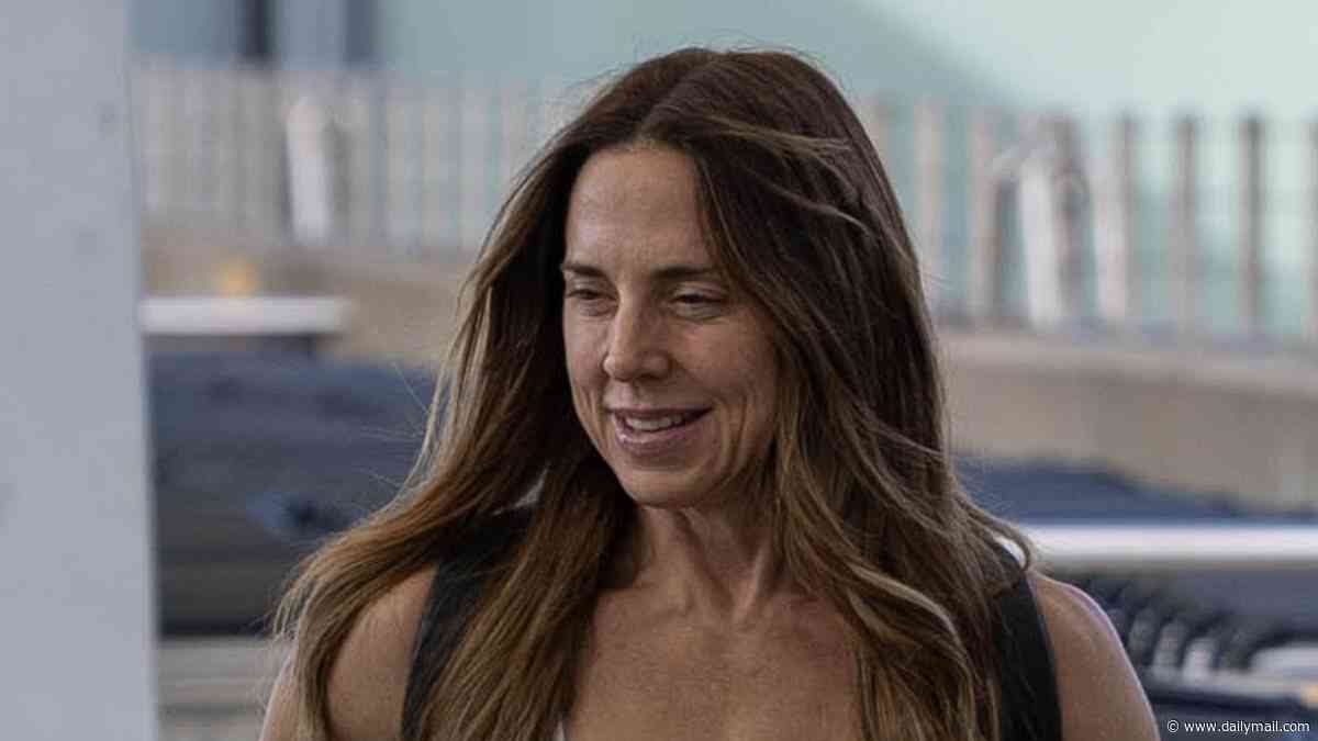 Mel C lives up to her Sporty Spice name as she shows off her toned arms as she and husband Chris Dingwall prepare to jet off at Heathrow airport