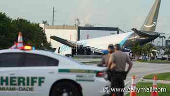 Dramatic footage shows rescue crews climbing into Amazon cargo plane that overshot runway in Miami as airport faces scrutiny for not using hidden safety system