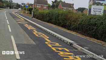 School keep-clear sign painted next to empty field