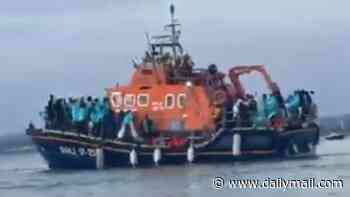 Flashpoint that triggered migrant fury: Moment dozens of protesters waded into sea to meet boat packed with 140 asylum seekers as it docks in Portsmouth - sparking clashes with riot police