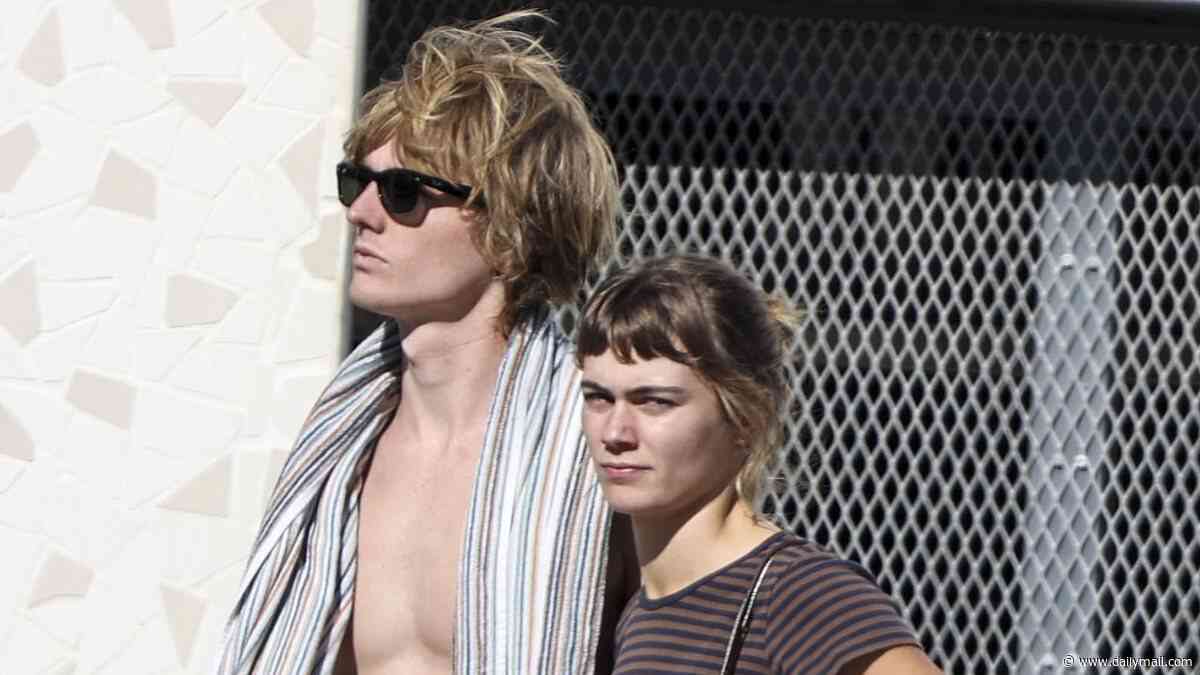 Bec and Lleyton Hewitt's 'nepo baby' daughter Mia puts on a VERY handsy display with her rocker boyfriend on Bondi Beach