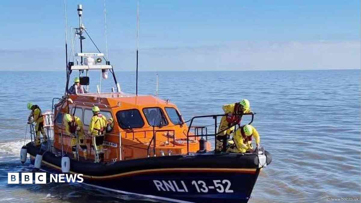 Four people rescued as sailing boat sinks off coast