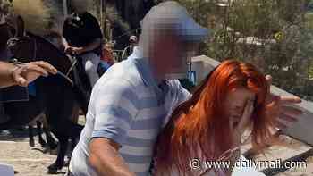 Moment enraged donkey owner attacks activist after she vowed to 'defend' animals being used to transport tourists in Santorini