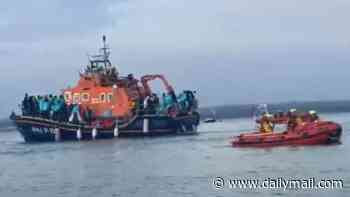RNLI boats carrying 140 migrants were denied entry to TWO ports before they landed at docks near Portsmouth and met by hundreds of protesters