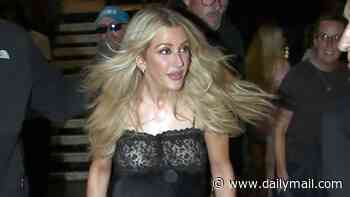 Ellie Goulding turns heads in a sheer lace dress as she she receives roses from a young fan while leaving her Manchester gig