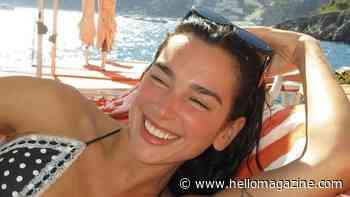 Dua Lipa showcases washboard abs in tiny bikinis during tropical vacation