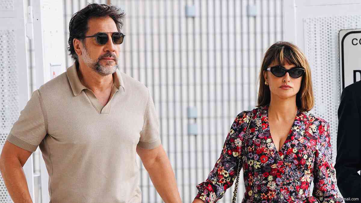 Penelope Cruz stuns in a floral dress as she holds hands with Javier Bardem after breaking down in tears during 15-minute standing ovation at Venice Film Festival