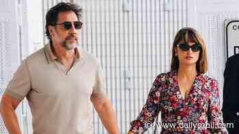 Penelope Cruz stuns in a floral dress as she holds hands with Javier Bardem after breaking down in tears during 15-minute standing ovation at Venice Film Festival