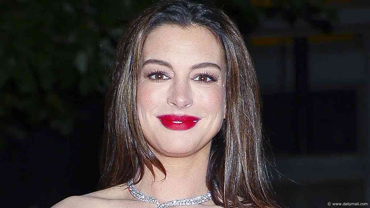Pregnant Anne Hathaway, 43, shows off her baby bump in an elegant mauve strapless dress at Bvlgari exhibition in New York