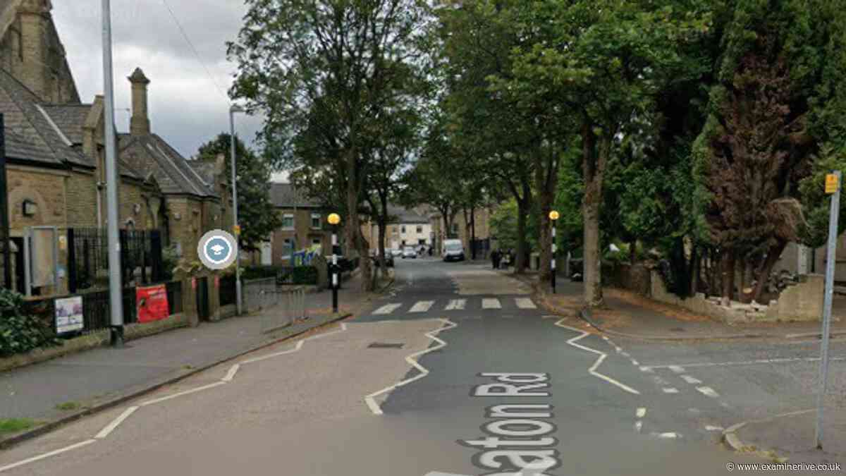 Car hits wall near Huddersfield school with roads shut and air ambulance landing