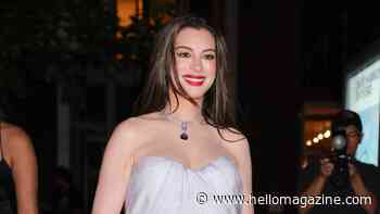 Pregnant Anne Hathaway cradles baby bump in breathtaking strapless dress