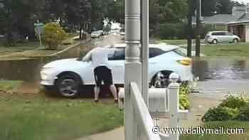 Shocking moment entitled driver is screamed at by elderly homeowner after she drove on his lawn during torrential downpour