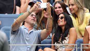 Brad Pitt, 52, snaps selfies with adoring fans and cuddles up to girlfriend Ines de Ramon, 33, during carefree day at US Open as ex Angelina Jolie speaks out on raising his estranged kids