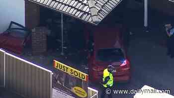 Two women fighting for life after two cars including a police vehicle smash into each other before crashing into neighbouring houses