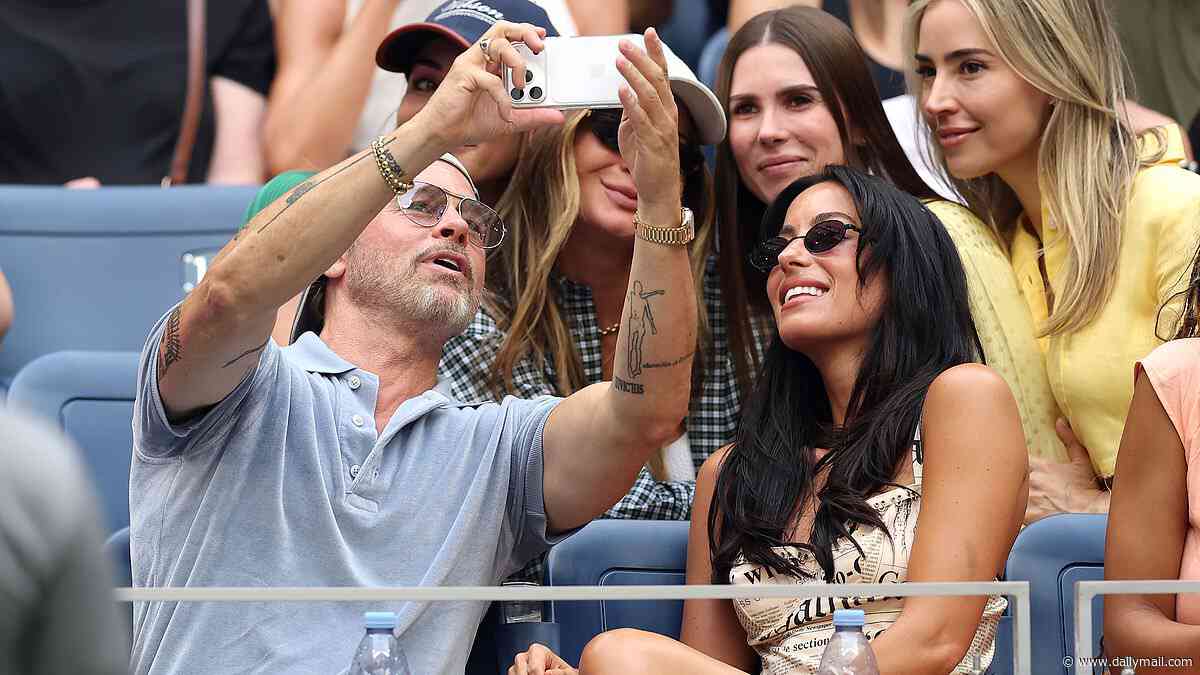 Brad Pitt, 62, snaps selfies with adoring fans and cuddles up to girlfriend Ines de Ramon, 33, during carefree day at US Open as ex Angelina Jolie speaks out on raising his estranged kids