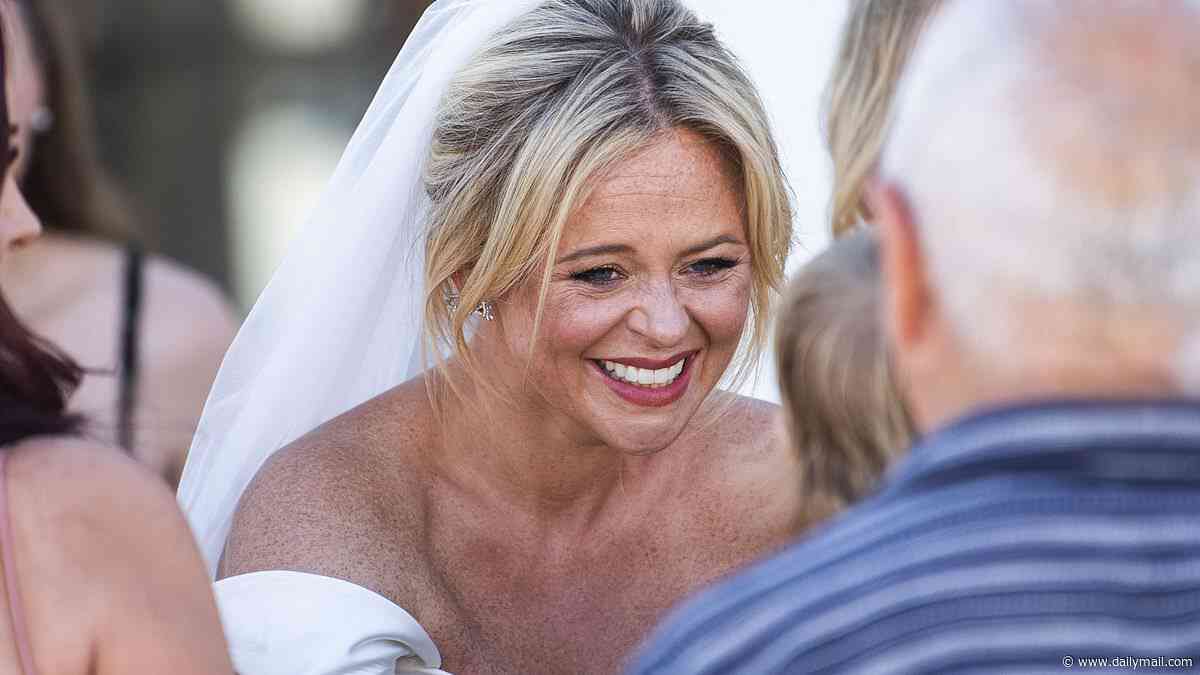 Emily Atack apologises to locals in the Spanish town of Mojacar as they watch her wed Dr Alistair Garner for the second time in a lavish ceremony