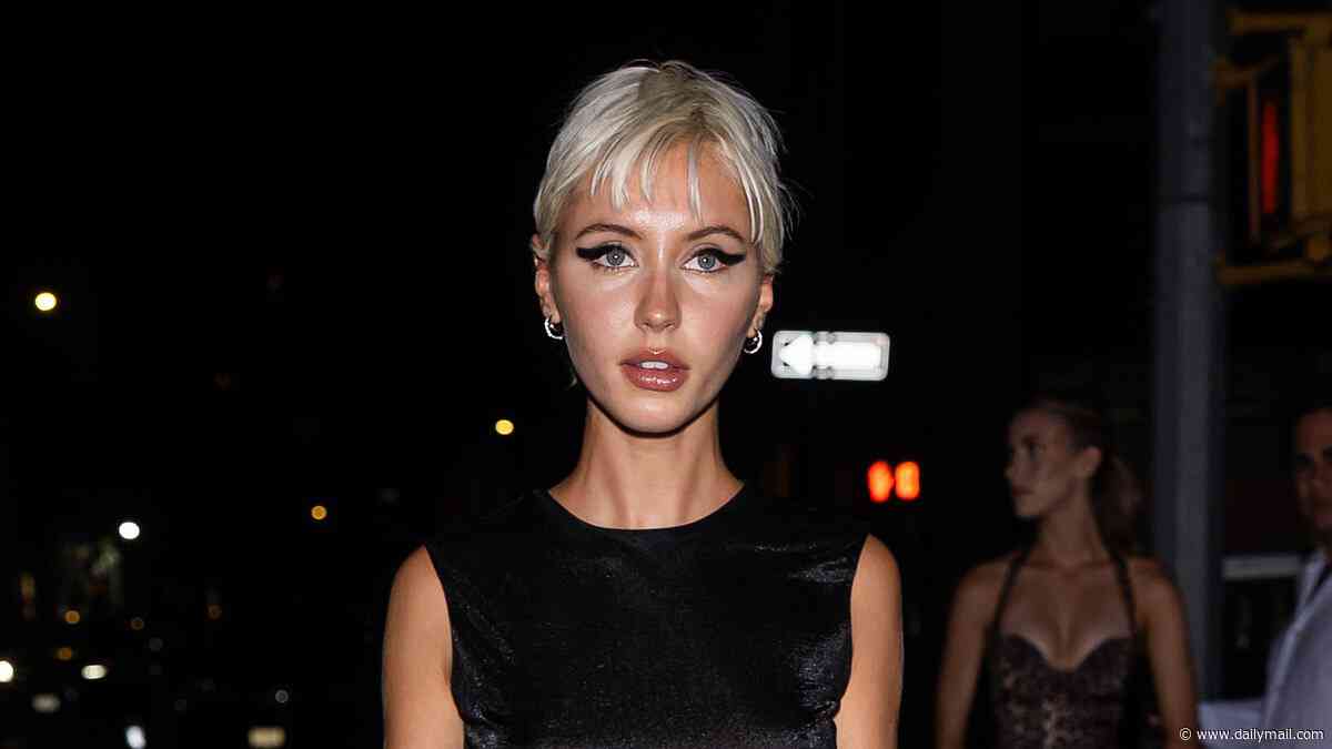 Iris Law parties in a feathered black mini dress after taking over the catwalk with fellow nepo baby Lila Moss during NY Fashion Week