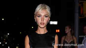 Iris Law parties in a feathered black mini dress after taking over the catwalk with fellow nepo baby Lila Moss during NY Fashion Week
