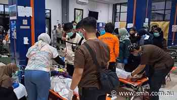 Dozens of rescued survivors from overturned ferry brought to Indonesian port