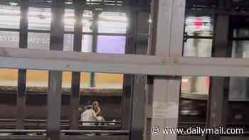 Shocking video shows man and woman causally sitting on subway tracks before being instantly killed when train barrels into station