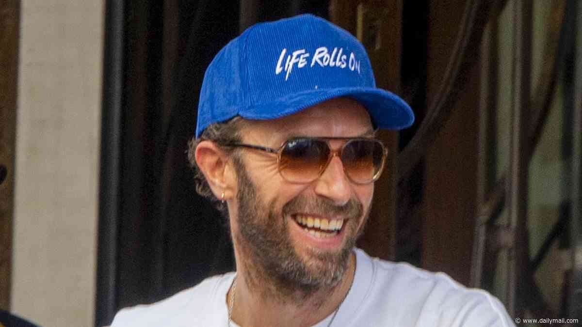 Chris Martin wears a 'life rolls on' cap as he is seen for the first time since ex Dakota Johnson sparked romance rumours with Machine Gun Kelly