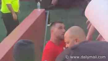 Travis Kelce slaps overeager fan's hand away as they try to snatch an item of his uniform before Chiefs opener