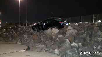 Car stranded on top of rocks at local marina