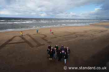 Activists write ‘naw’ to AI on beach as execs set to fly in for summit with King