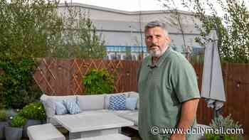 Homeowner has £170,000 wiped off value of his dream house after FOUR 60ft-high mega warehouses are built next door