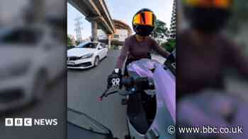 Indian police detain driver who hit female biker in viral video