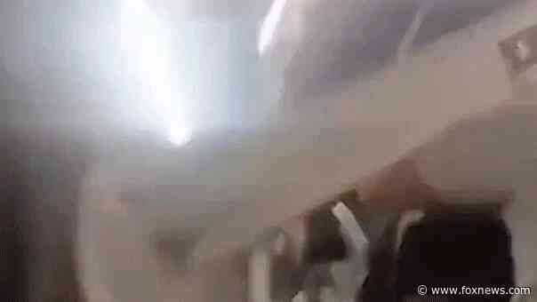 Plane passengers scream in harrowing mid-flight video as violent shaking sends cabin ceiling panels flying