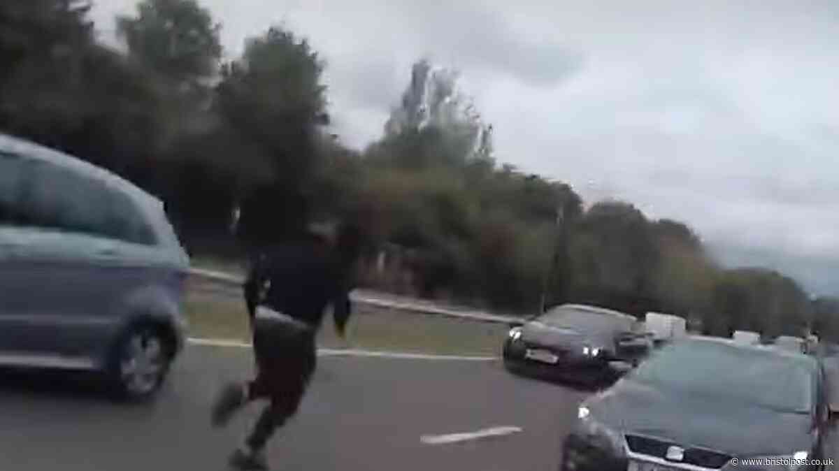 Crazy moment man runs onto A-road after dramatic police chase