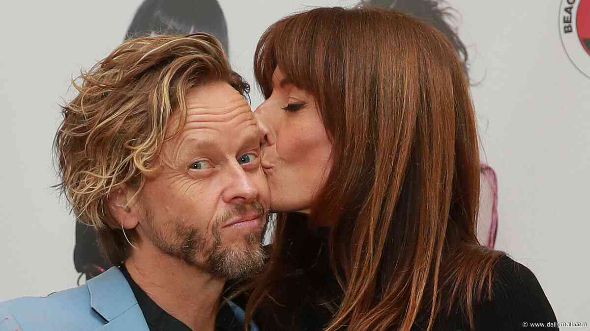 Davina McCall puts on a leggy display in a black minidress as she packs on the PDA with husband Michael Douglas at a launch party in London