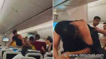Two men throw punches at each other during flight from Bangladesh to London, with one man losing his T-shirt during the brawl
