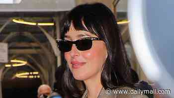Beaming Dakota Johnson has a spring in her step while promoting her new film after sparking romance rumours with Machine Gun Kelly