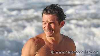 Shirtless Orlando Bloom is ripped in James Bond-worthy beach appearance