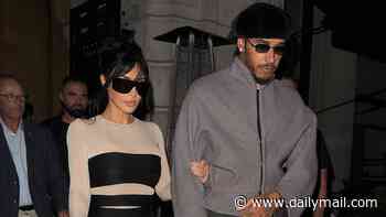 Lewis Hamilton shows his chivalrous side as he places a gentle hand on Kim Kardashian's back after a romantic date night in London - ahead of her pal Chris Appleton's Strictly debut