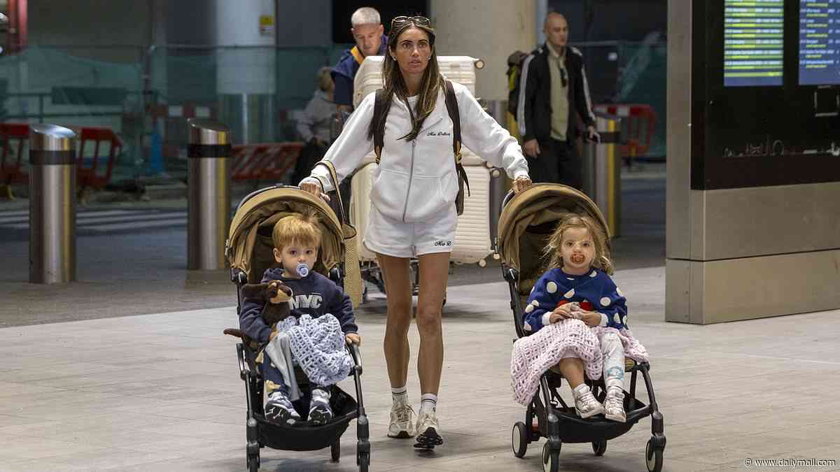 Amy Childs wears a 'Mrs Delbosq' tracksuit as she arrives at the airport laden with luggage ahead of her second wedding in Spain