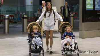 Amy Childs wears a 'Mrs Delbosq' tracksuit as she arrives at the airport laden with luggage ahead of her second wedding in Spain