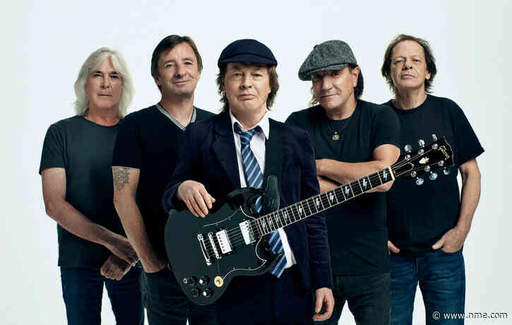 Watch AC/DC’s Angus Young sign fan’s baby