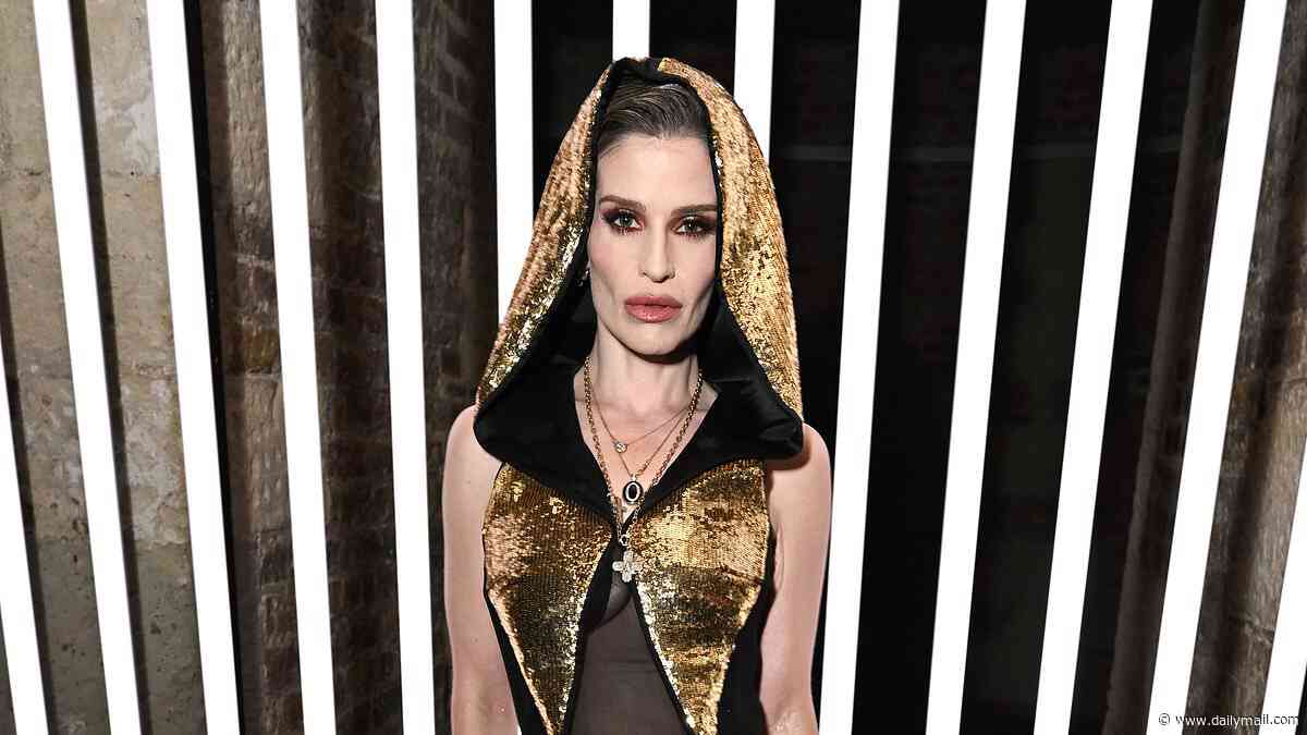 Kelly Osbourne turns heads in a hooded gold jumpsuit as she attends John Richmond's London Fashion Week show after hitting the catwalk