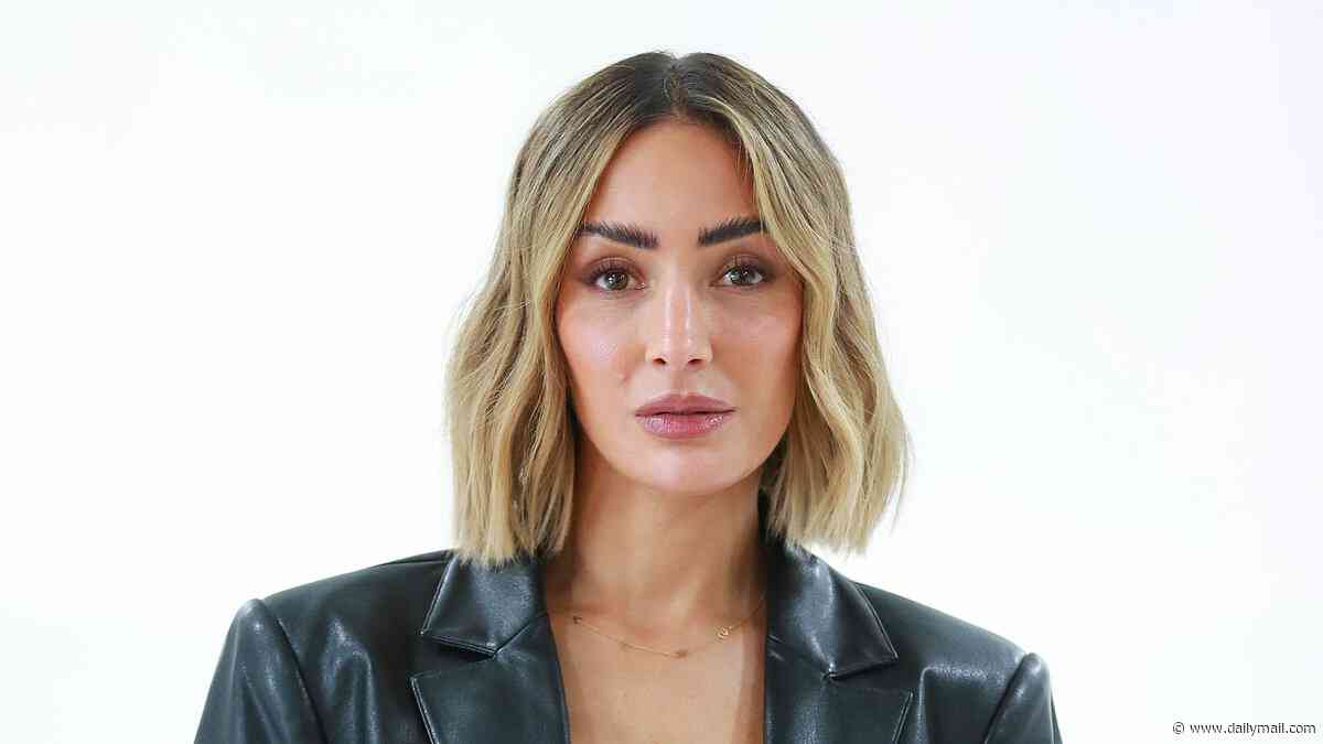 Frankie Bridge shows off her abs in a tiny black bra and leather jacket as she hosts London Fashion Week event