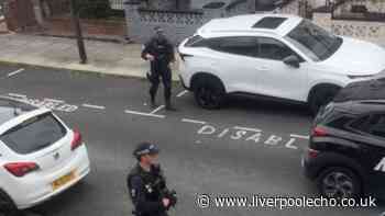 Weapons seen, car damaged and arrest made as armed police descend on city street
