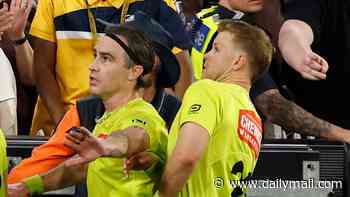 Ugly scenes after one of the great AFL preliminary finals as umpires dodge bottles thrown by Hawthorn Hawks fans over the 'biggest call you've ever seen' against Brisbane Lions