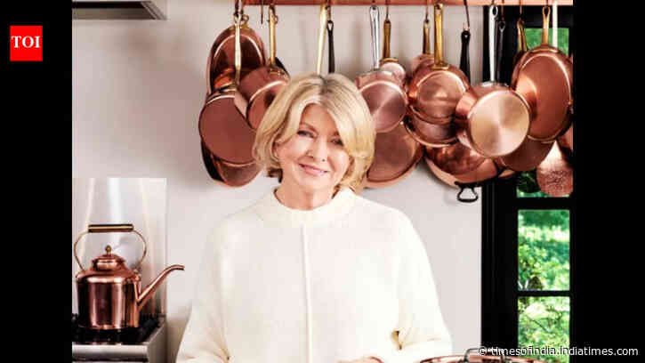 Martha Stewart's black and copper-themed kitchen is the ultimate cookplace makeover; deep shelves spotlight brass, copper