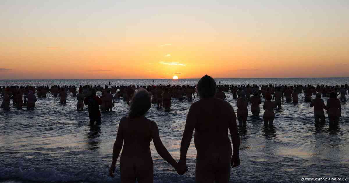 Hundreds of swimmers strip off and brave North Sea for UK's largest skinny dip in Northumberland